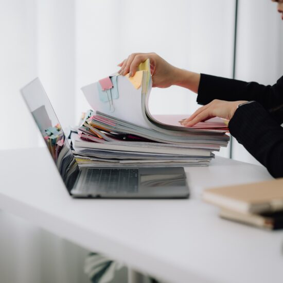 Woman,Reviewing,Legal,Documents,At,Desk